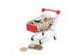 Red miniature shopping cart filled with new 10 Thai Baht coins. Royalty Free Stock Photo