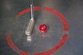 Red minigolf ball with an iron racket at the minigolf playground