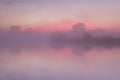 Red misty sunrise over calm lake Royalty Free Stock Photo