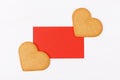 Red mockup greenting card with two heart shape cookies on a white backround. Simbol of cozy love and Valentines Day backrgound and