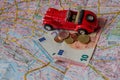 Red Model Car and Money Scattered on Tourist Map