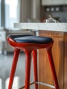 Red modern barstool in a contemporary kitchen setting. Royalty Free Stock Photo