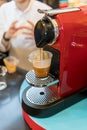 A red modern looking espresso coffee machine is making a coffee Royalty Free Stock Photo