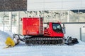 Red modern snowcat ratrack with snowplow snow grooming machine preparing ski slope piste hill at alpine skiing winter Royalty Free Stock Photo