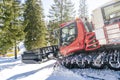 Red modern snowcat ratrack with snowplow,snow grooming machine,remover truck preparing ski slope,piste,hill at alpine skiing Royalty Free Stock Photo