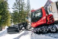 Red modern snowcat ratrack with snowplow,snow grooming machine,remover truck preparing ski slope,piste,hill at alpine skiing Royalty Free Stock Photo