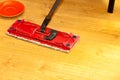 Red mop cleaning wooden floor Royalty Free Stock Photo