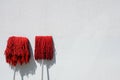 Red mop and white background wall Royalty Free Stock Photo