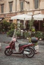 Moped parked on street in front of cafe in Trastevere, Rome, Italy Royalty Free Stock Photo