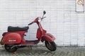 Red motorbike in front of a white wall