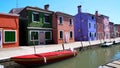 Red motorboat parked on Venetian canal, beautiful colorful houses, Burano Royalty Free Stock Photo