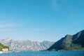 Red motorboat sails on a bay near a mountainous coast Royalty Free Stock Photo