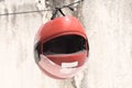 Red motorcycle helmet hanging on the clothes line