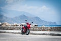 Red motorcycle near sea coastline at Paleochora town on Crete island