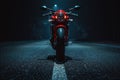 A red motorcycle parked on the side of a road, perfect for editorial or commercial use Royalty Free Stock Photo