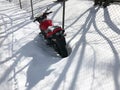 Red motorcycle stands in a snowy parking lot covered in snow in winter Royalty Free Stock Photo