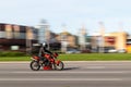 A red motorcycle is traveling at high speed on the road. Triumph Street Triple. Motion blur. Riga, Latvia - 09 Sep 2021