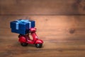 Red motorcycle vespa are Transporting Blue gift box Royalty Free Stock Photo