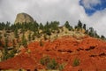 Red Mountain Cliffs with Devils Tower in the Background Royalty Free Stock Photo