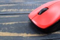 Red mouse from a computer on a black table
