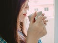 Red mouth of asian girl in blue pajamas and hold hot coffee for Royalty Free Stock Photo