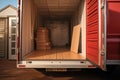 A red moving truck with boxes loaded in the back, ready for transport., New home transition symbolized by a loaded Royalty Free Stock Photo