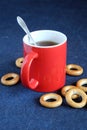 Red mug of black tea and dryings are on the table close-up Royalty Free Stock Photo