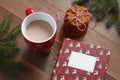 Red mug of cocoa, Christmas book and pile of cookies on the wooden table Royalty Free Stock Photo