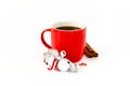 Red Coffee Mug with Jingle Bells and Cinnamon Sticks on White Royalty Free Stock Photo