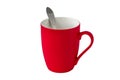 Red mug with handle and metal spoon close-up isolated on a white background Royalty Free Stock Photo