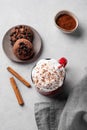 Red mug with hot chocolate or cocoa with whipped cream, cookies, spoon, cinnamon sticks and star anise