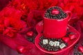 Red mug with LOVE letters rosted coffee beans sexy red background