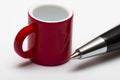 Red mug and pen on white background Royalty Free Stock Photo