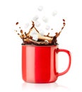 red mug with a splash of coffee and falling marshmallows Royalty Free Stock Photo
