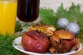 Red mulled wine and bakes apples meal with honey and spice. Spruce background.