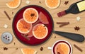 Red mulled wine in a pot with orange slices, cinnamon, cloves and a bucket. Two white mugs of mulled wine. Flat lay