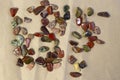 Red and multicolored jasper polished tumblestones as nice natural background on craft paper