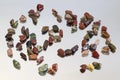 Red and multicolored jasper polished tumblestones as nice natural background on mirror