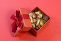 Red and multicolored jasper polished tumblestones as nice natural background in red gift box