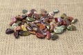 Red and multicolored jasper polished tumblestones on light grey background Narrow focus line, shallow depth of field