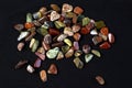 Red and multicolored jasper polished tumblestones on black background