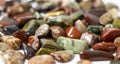 Red and multicolored jasper polished tumblestones narrow focus line shallow depth of field macrophoto