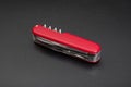 Red multitool knife on black background Royalty Free Stock Photo