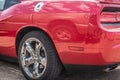 Red muscle car`s chrome wheel close up