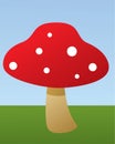 Red mushroom in a field with sky and grass