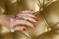 Red nail hand with a two hart bracelet Royalty Free Stock Photo