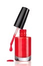 Red nail polish bottle with drop on white Royalty Free Stock Photo