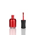 Red nail polish glass bottle, brush & mirror reflection white background isolated close up, open varnish package & shadow, lacquer Royalty Free Stock Photo