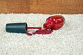 Red nail polish spill on carpet