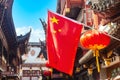 Red national flag of China against old chinese buildings at Yuyuan Garden in Shanghai, China